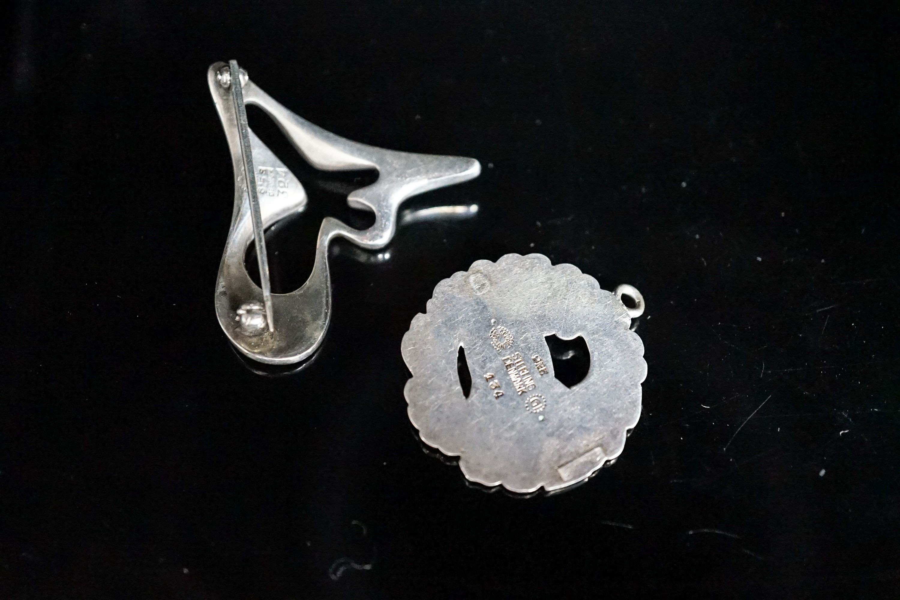 A Georg Jensen sterling abstract brooch, no. 324, 41mm and a Georg Jensen sterling pendant (converted brooch), no. 134.